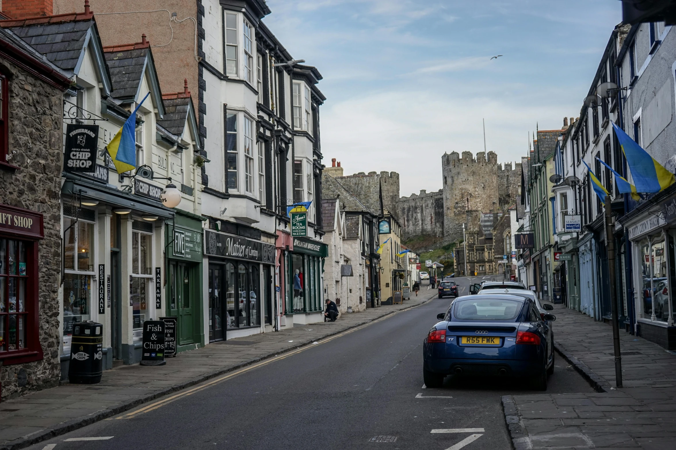 a car that is parked on the street in front of buildings