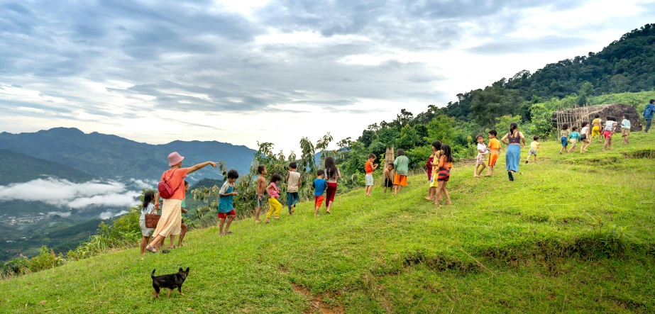 people climbing up a mountain hill in the countryside