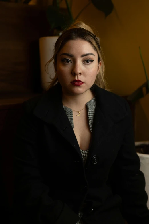 a young woman in a dark room posing for a po