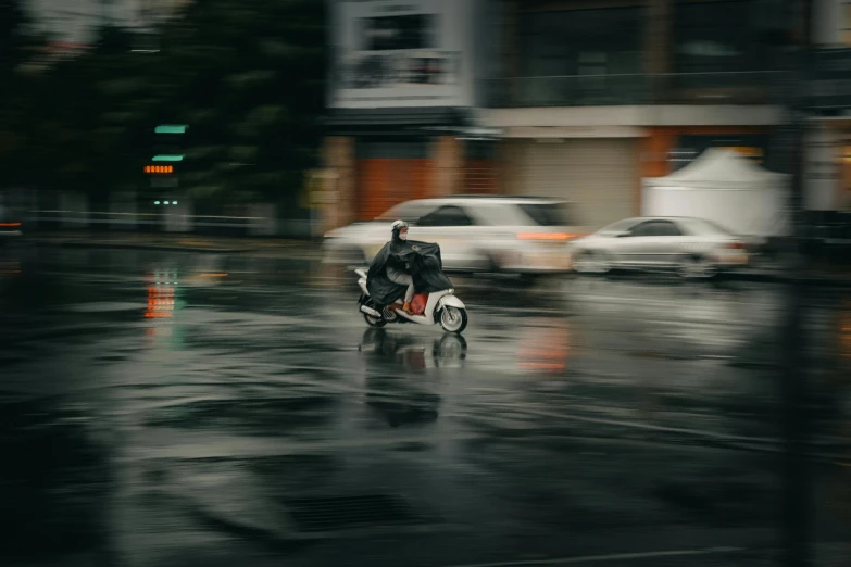 man riding on motor bike in the rain