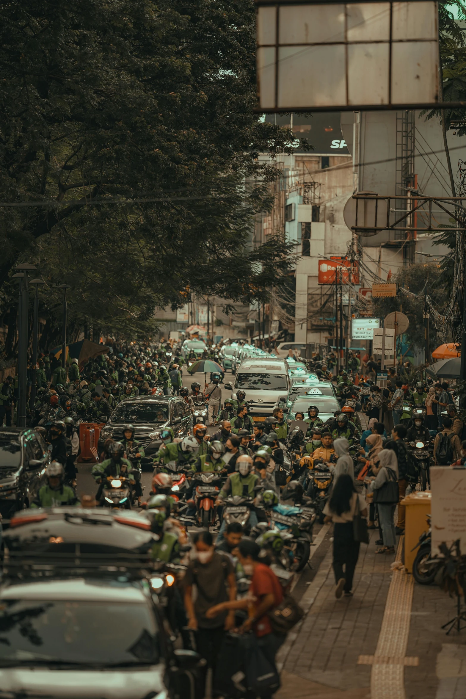 a crowded city street with a motorcycle rally