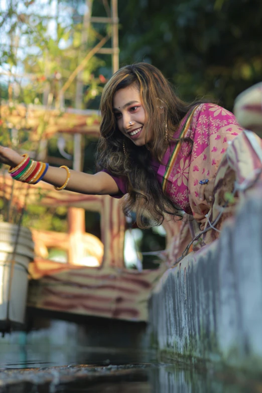 a girl is playing in the water outside