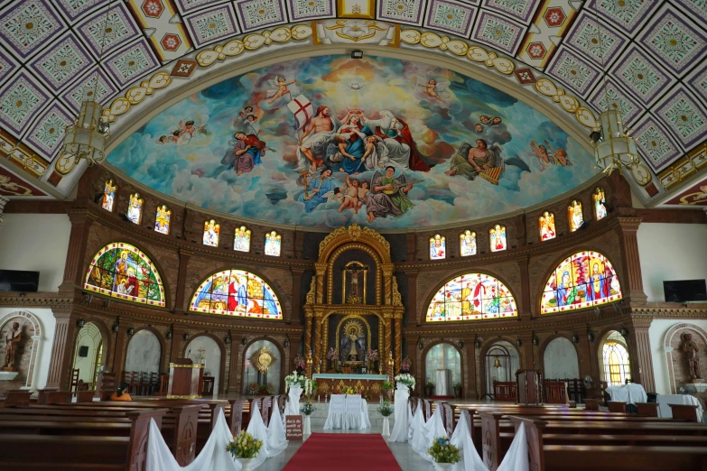 a cathedral with beautiful stained glass windows and pews