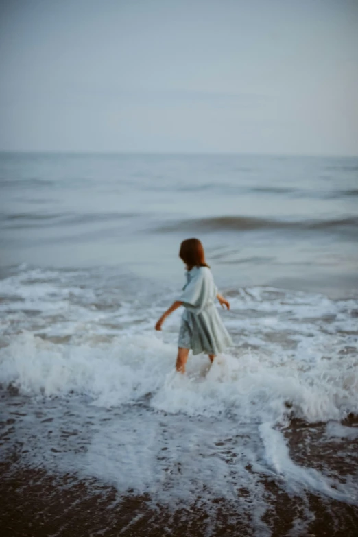 little girl playing in the surf at the beach