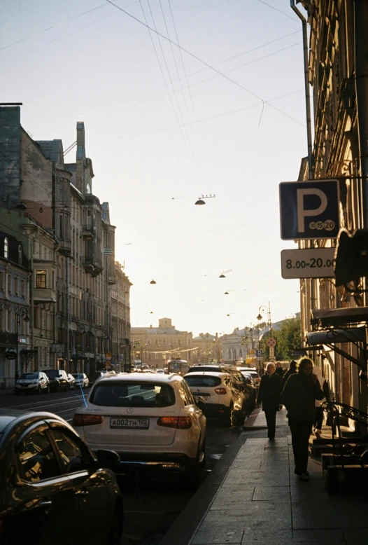 some people are walking down a narrow street