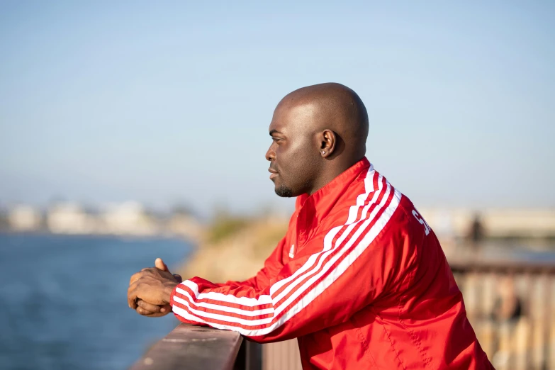 a man is standing outside looking at the water