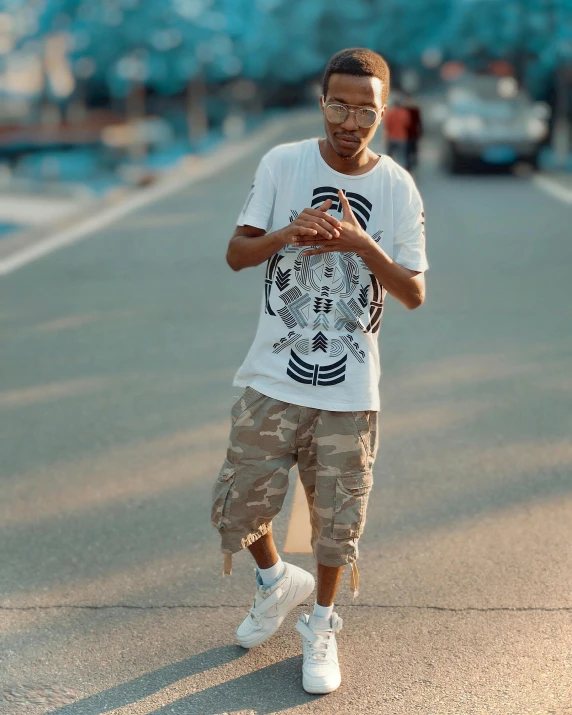 a man in white shirt and khaki pants standing in the street