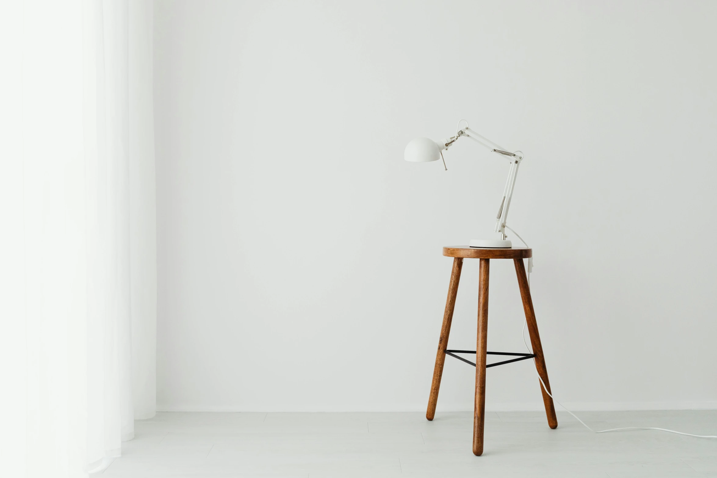 a table and chair next to a wall