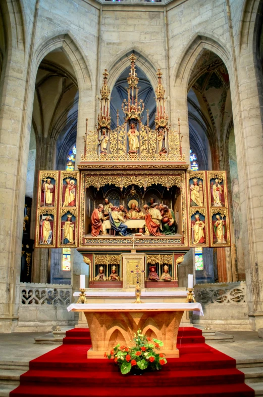 the alter of a church with a wreath and flowers on it