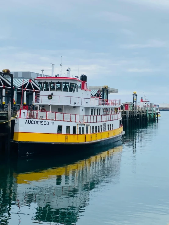 a large ferry boat docked at a pier