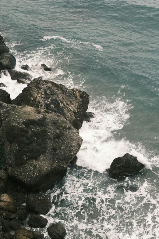 the coast is next to the rocks in the ocean