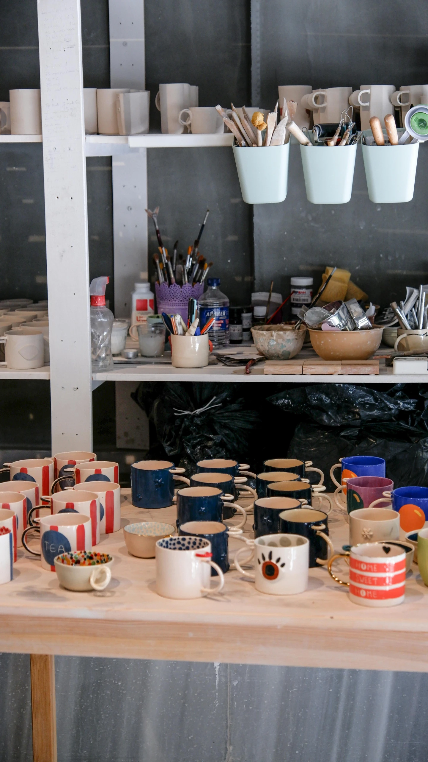 bowls and containers sitting on a table with some cups on them