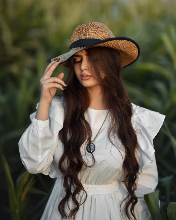 a woman with long hair wearing a straw hat