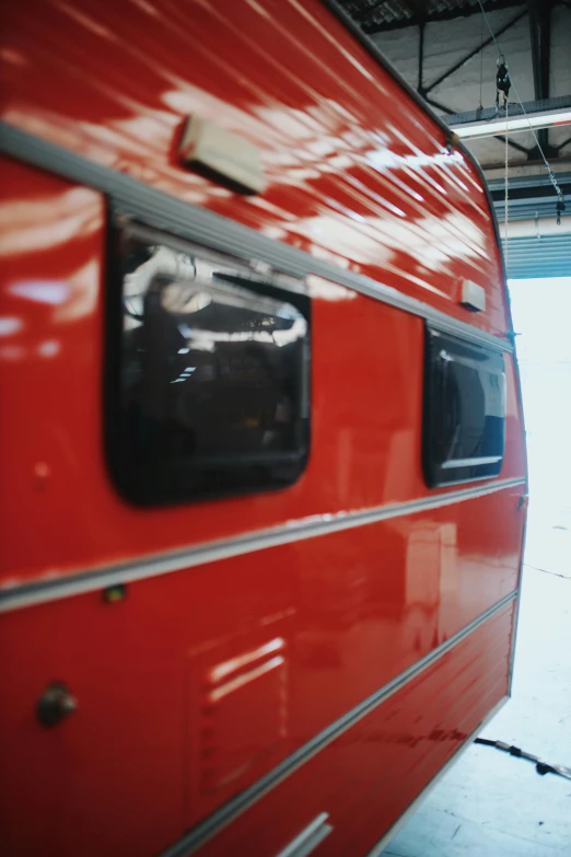 the rear end of an older red bus