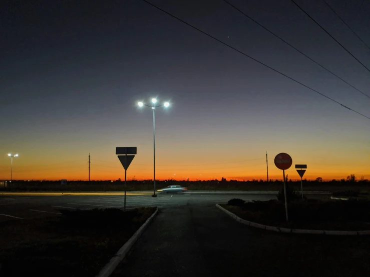 a long dark road with some street signs