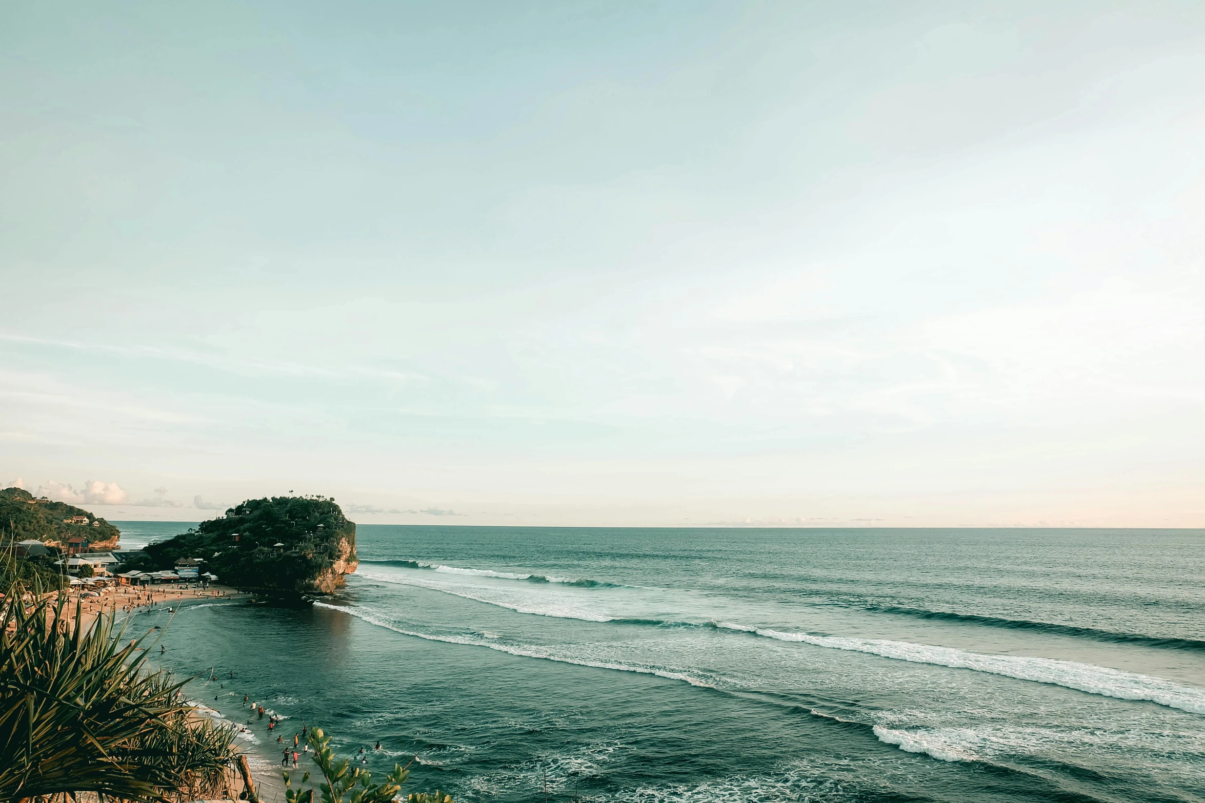 a beach with some waves coming in to shore