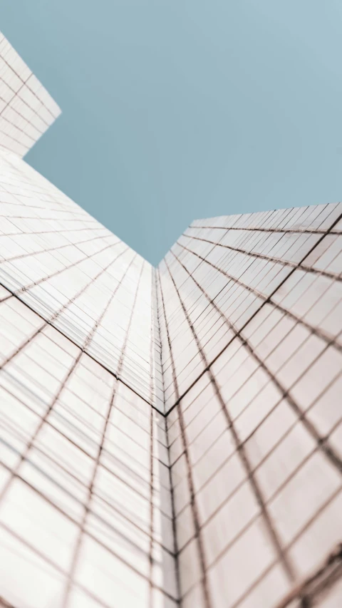 the bottom of a tall glass building looking up