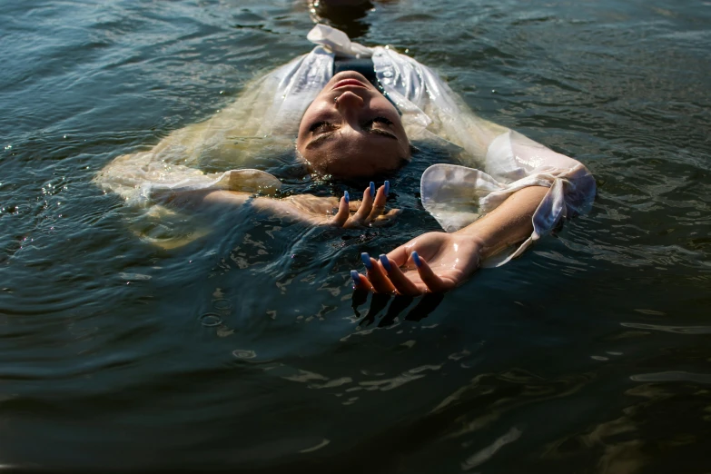 a woman floating on top of a body of water