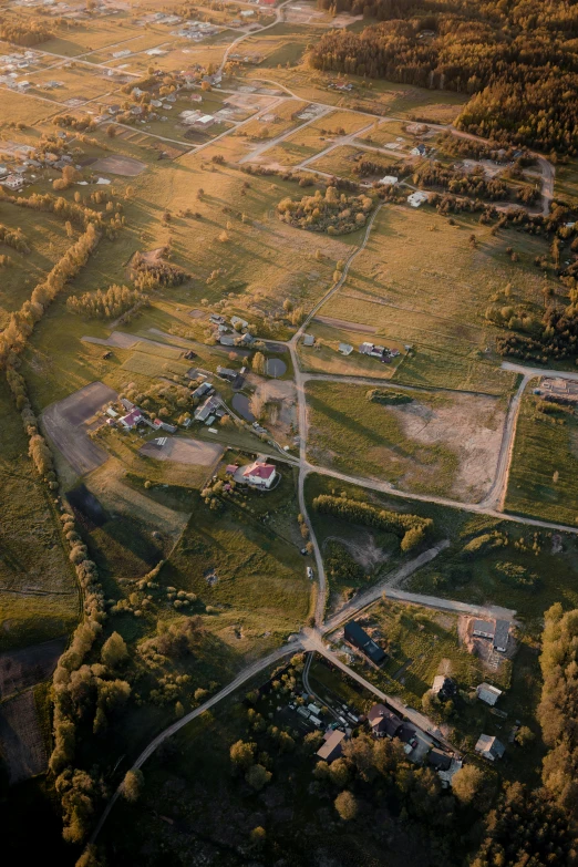 an aerial po of a field surrounded by land