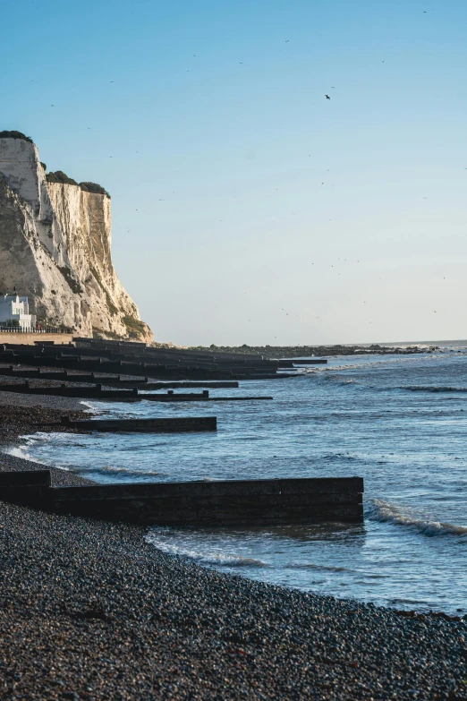 a body of water next to a rocky beach