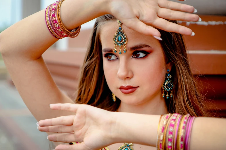 young woman in belly ring and headpiece posing for camera