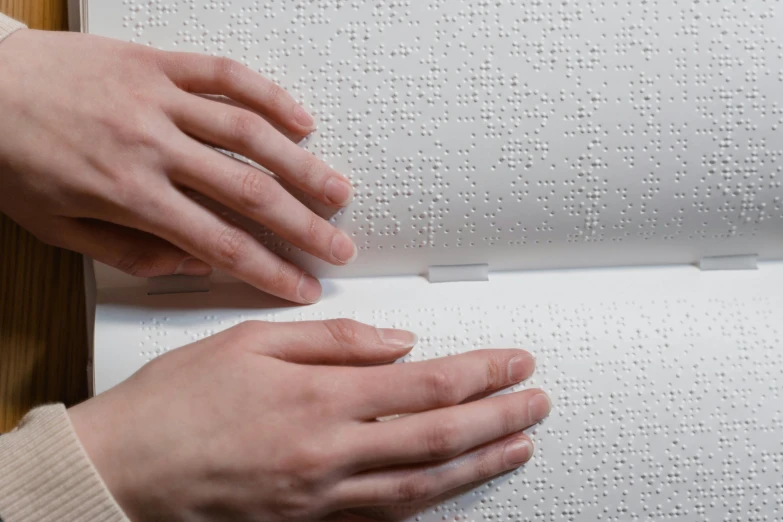 hands are holding up the outer part of a piece of fabric