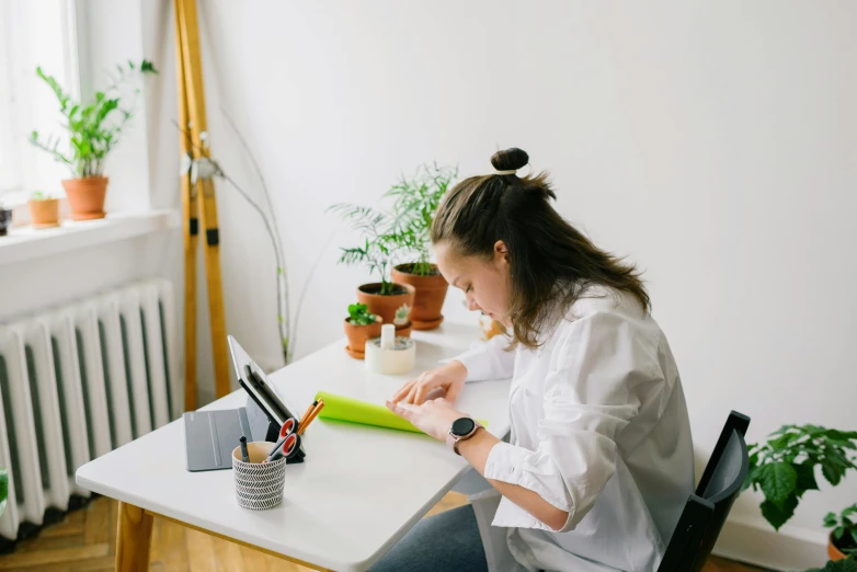 there is a woman on her computer at the desk