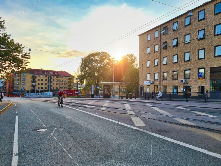 people ride their bikes down the deserted city street