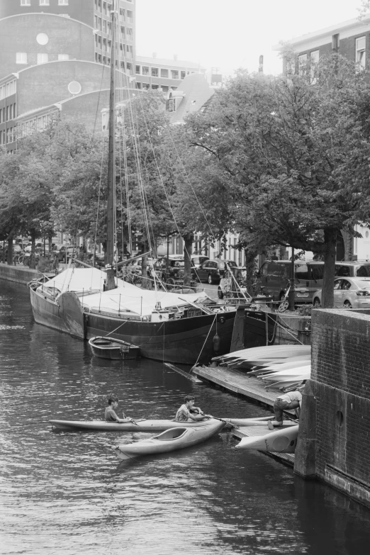 a black and white po with boats docked on the river