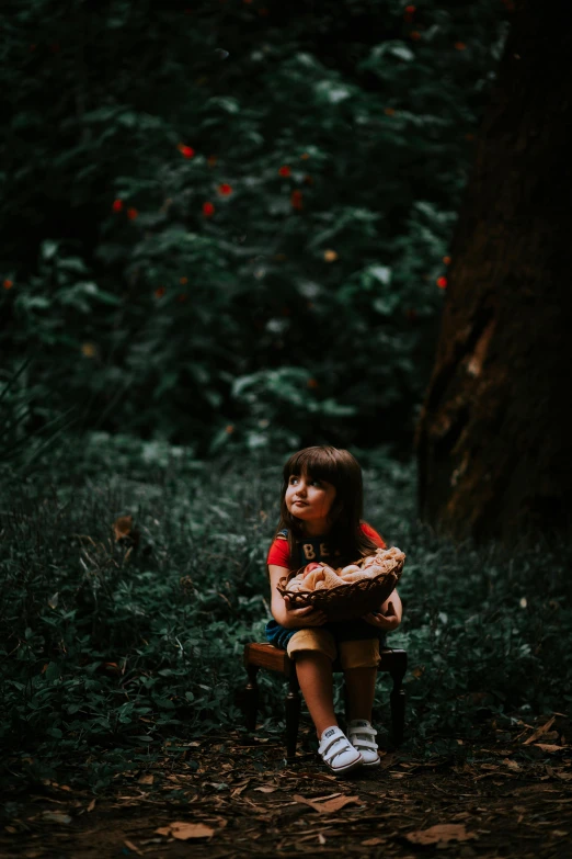 a  sitting on a bench in the woods