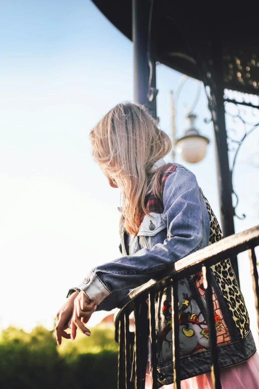 woman standing with her hand on the railing