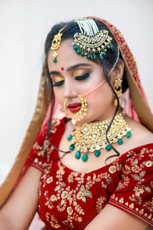 a girl dressed in red is wearing jewelry