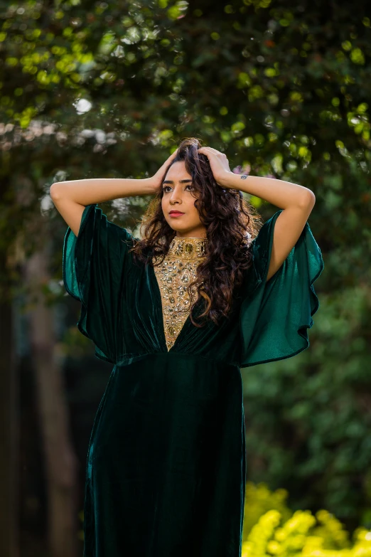 a woman wearing green is posing for a po