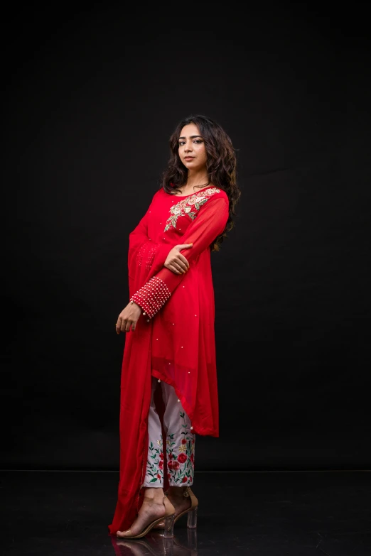 a woman in a red dress posing for a portrait