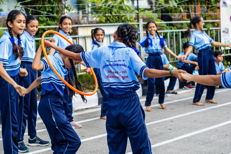 s performing with hula hoops in the street