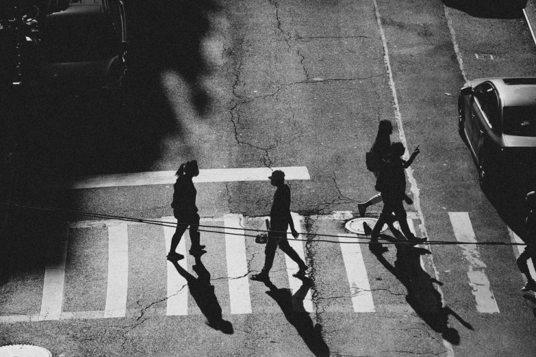 a group of people crossing a street on the crosswalk