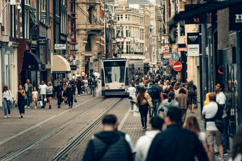 the busy city street is crowded with people