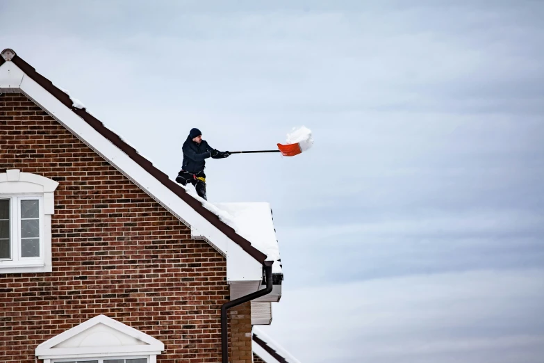 a man working on a roof in a residential area