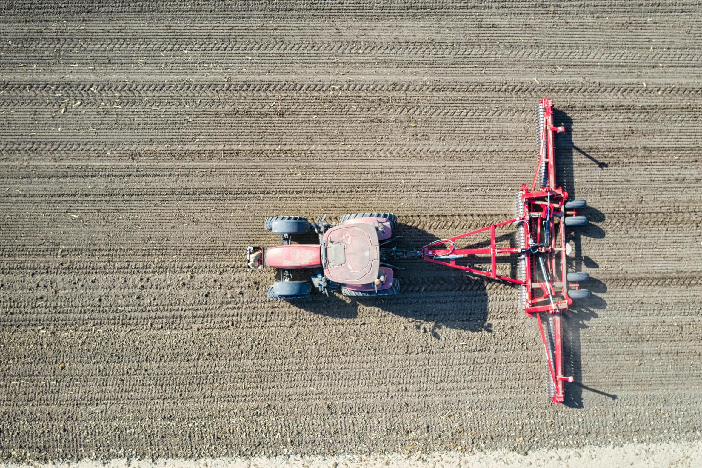 a red tractor on top of an open field