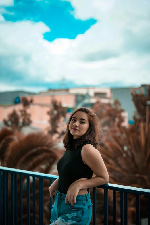 an attractive woman is posing on the balcony