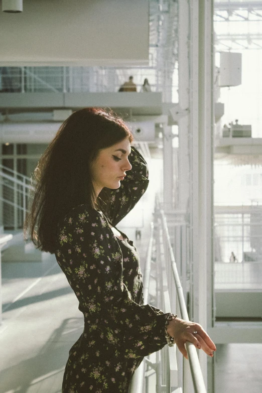 woman standing on balcony rail posing for camera