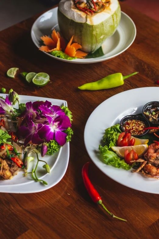 a wooden table topped with plates full of food