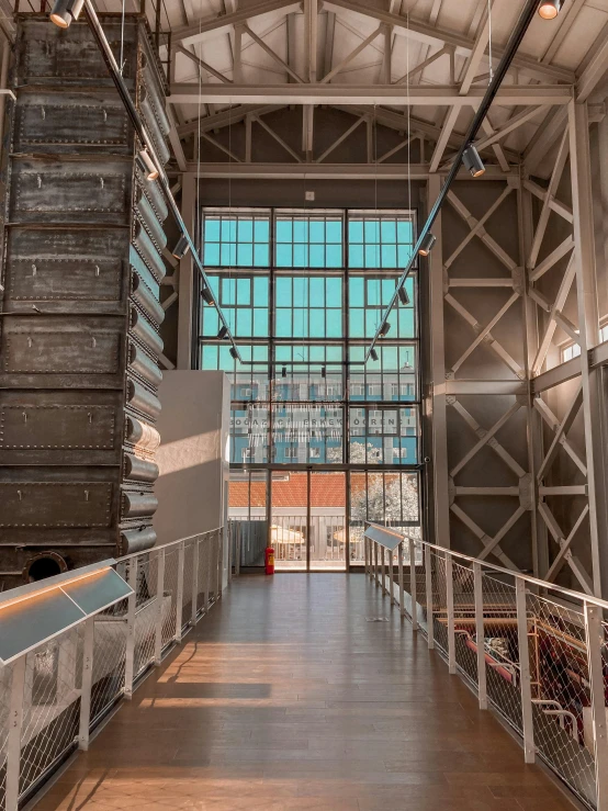 inside the building a steel structure has lots of windows and fencing