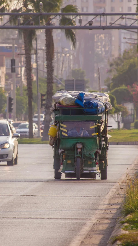 a very big green wagon with some bags in it