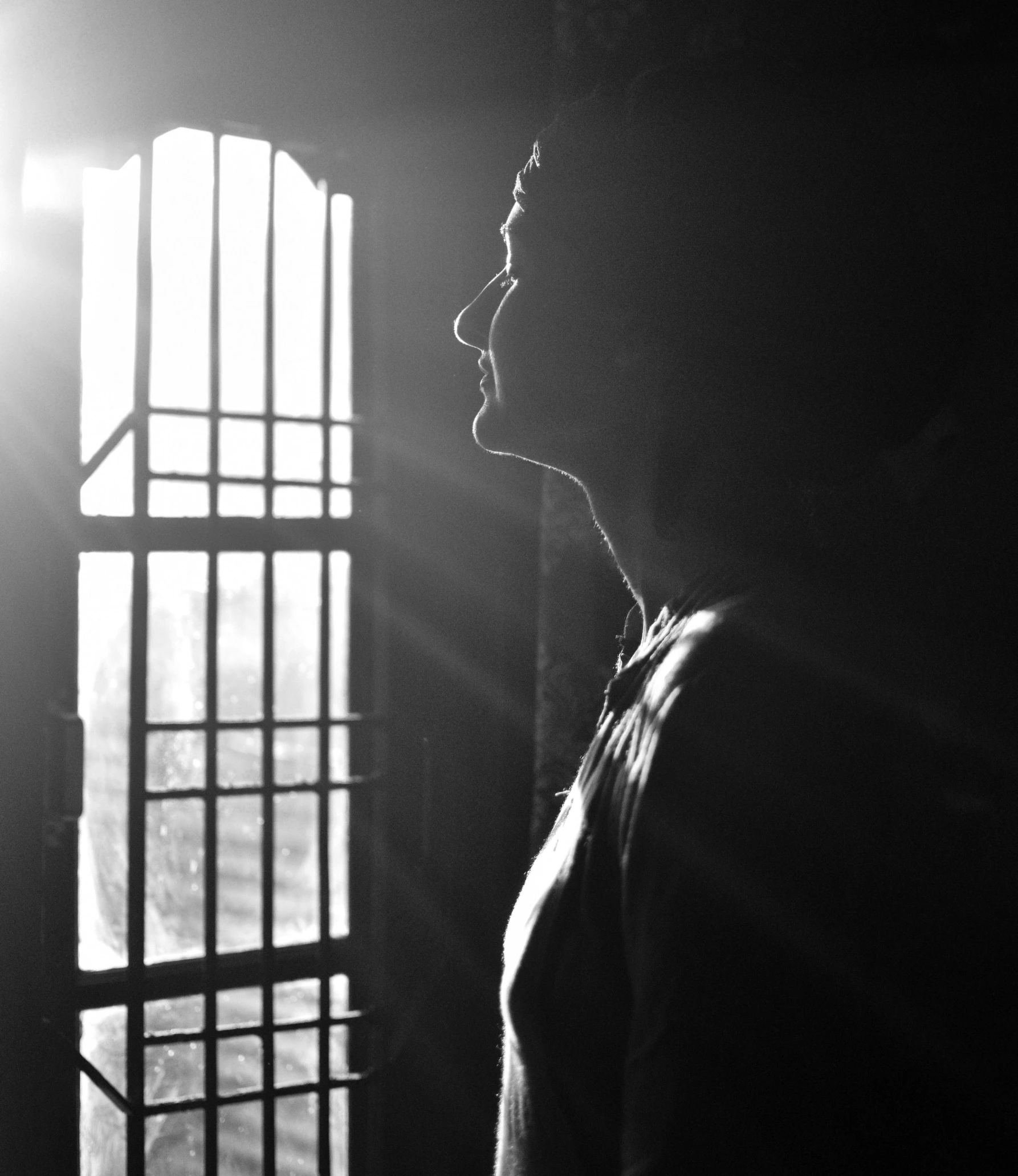 a man standing in the doorway looking out from behind a bar