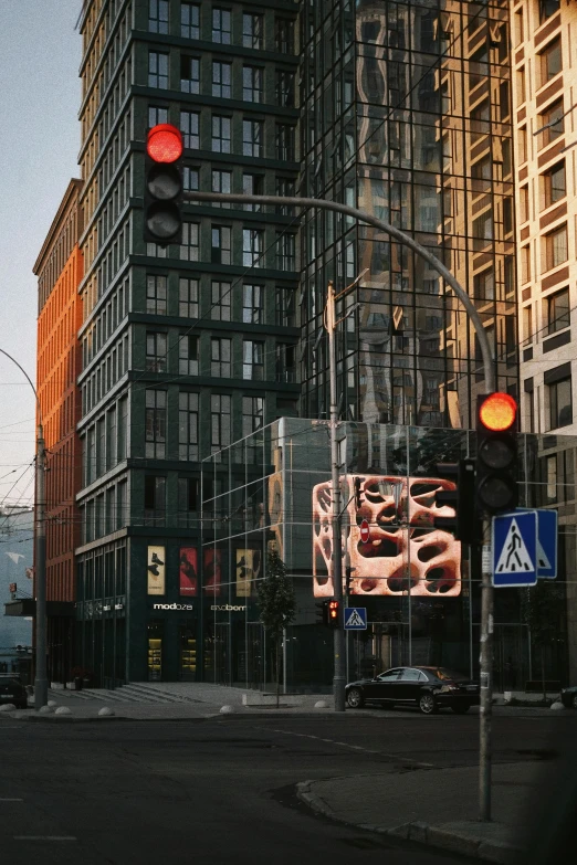 a traffic light with some large buildings and signs on the street