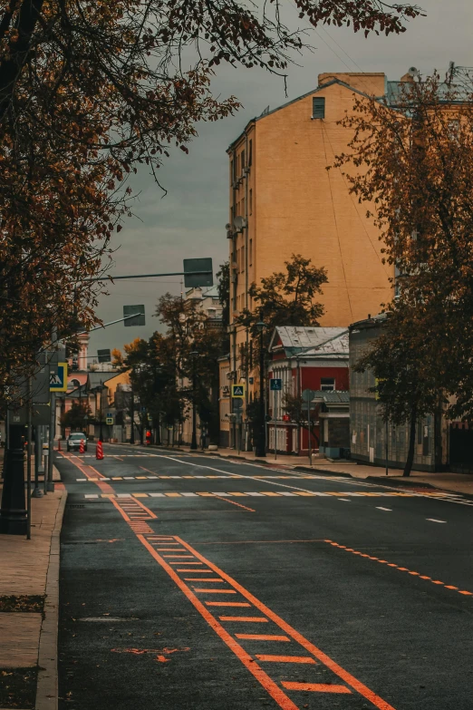 a quiet city street with a few signs on the corner