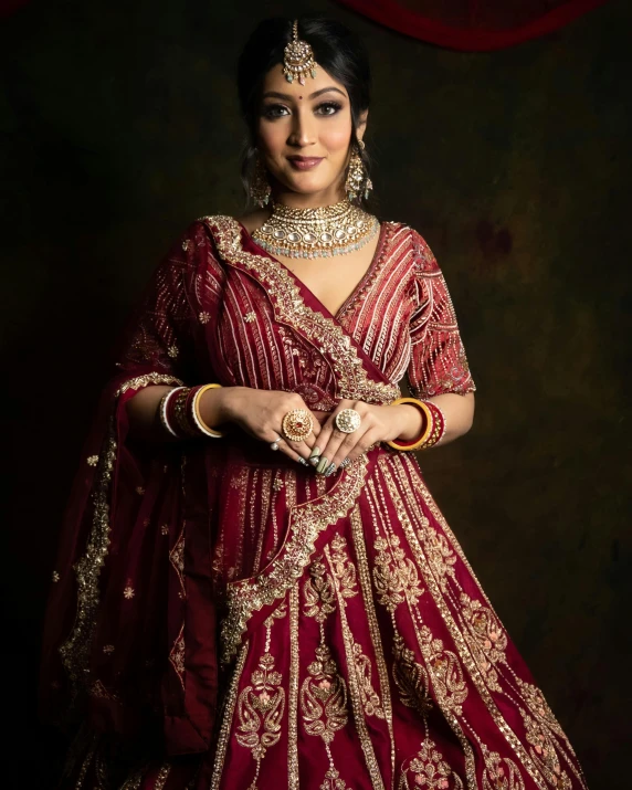 an indian bride dressed in red and gold