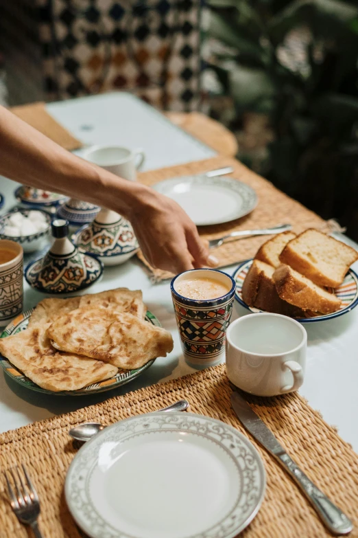 a person is putting a toast in front of bread