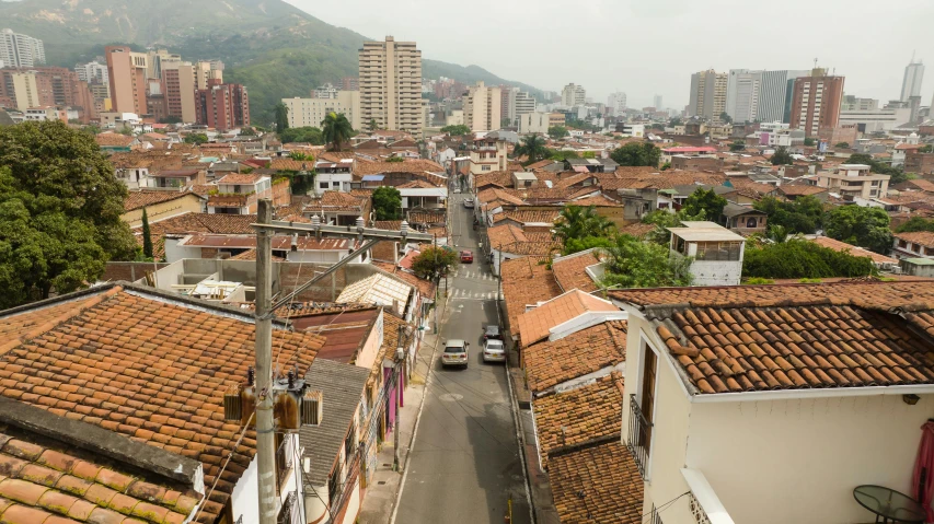 a city scene with a street and many houses